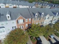 Aerial view of townhouses with brick and siding exteriors, driveways, and landscaping at 6148 Indian Wood Se Cir, Mableton, GA 30126