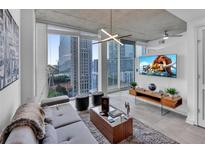 Modern living room with city views and large TV at 3324 Ne Peachtree Ne Rd # 1110, Atlanta, GA 30326