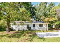 Ranch home with gray siding and front yard at 3215 Highway 20 Se, Conyers, GA 30013