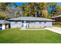 Gray house with green lawn, walkway, and driveway at 1868 Longdale Dr, Decatur, GA 30032