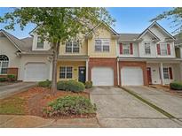 Two-story townhome with attached garage and landscaping at 2359 Suwanee Pointe Dr, Lawrenceville, GA 30043