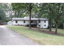 Single-story home with attached garage and large yard at 3219 Boulder Brook Dr, Lithonia, GA 30038