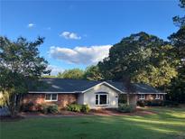 Brick ranch house with a large yard and mature trees at 1078 Highway 92 S, Fayetteville, GA 30215