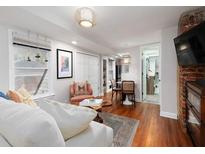 Bright living room with hardwood floors, comfy seating, and exposed brick wall at 830 Barnett Ne St # 5, Atlanta, GA 30306