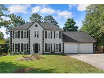 Two-story house exterior with a two-car garage and manicured lawn at 1164 Interlaken Pass, Jonesboro, GA 30238