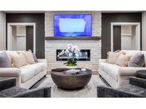 Elegant living room with a fireplace, comfortable seating, and large TV at 3351 Orwell Way # 2105, Cumming, GA 30041