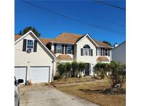 Two-story house with attached garage and landscaping at 4769 Snap Creek Ln, Decatur, GA 30035