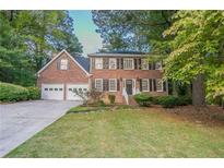 Brick house with two-car garage and landscaped yard at 2097 Kolb Ridge Sw Ct, Marietta, GA 30008