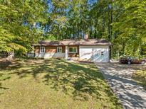 Front view of the single-story home with attached garage and driveway at 5051 Heather Se Rd, Smyrna, GA 30082