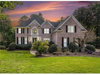 Brick house with manicured lawn and landscaping at 1667 Angelica Ct, Lawrenceville, GA 30043