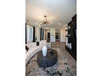 Modern living room with curved sofa, large windows, and a stylish media wall at 392 Pratt Se Dr # 2012, Atlanta, GA 30315