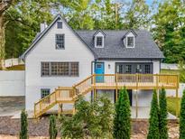 White two story home with gray accents, deck and stairs at 2552 Hunton Ne Ct, Marietta, GA 30068