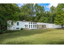White ranch house with a large grassy yard at 115 Wilkins Rd, Fayetteville, GA 30214