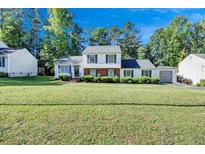 Ranch style home with brick and white siding, landscaped lawn at 2225 Pleasant Hill Rd, Atlanta, GA 30349