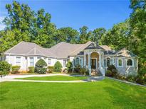 Brick house with a large front yard and a manicured lawn at 1565 Mountain Shadow Trl, Stone Mountain, GA 30087