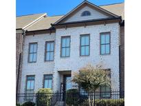 Beautiful two-story home with white brick exterior and landscaping at 3517 Village Park Nw Way, Kennesaw, GA 30144