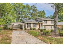 House exterior with carport and landscaped yard at 139 Old Mill Sw Trl, Conyers, GA 30094