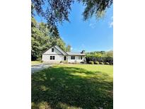 Charming white house with green lawn at 2735 Sandy Creek Cir, Loganville, GA 30052