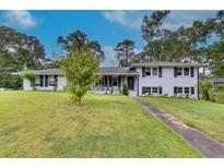 Ranch house with white brick exterior and landscaping at 903 Bingham Ln, Stone Mountain, GA 30083
