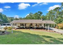 Ranch home with front porch and landscaped yard at 2298 Cole Lake Rd, Dallas, GA 30157