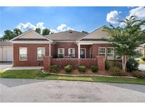 Brick ranch home with a landscaped yard and covered porch at 205 Villa Park Cir # 205, Stone Mountain, GA 30087