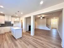 Open concept kitchen with island and view into living room at 1880 Aron Ln # 068, Conyers, GA 30013