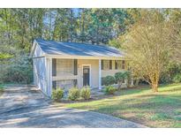 Brick ranch home with dark door and landscaping at 4660 Edwina Sw Ln, Atlanta, GA 30331