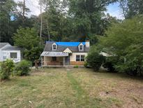 Small house with blue tarp covering roof, needs renovation at 879 Edwin Nw Pl, Atlanta, GA 30318
