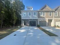 Modern townhome with attached garage and stone accents at 5730 Calle Vista Dr # Bv001, Lithonia, GA 30058