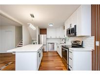 Modern kitchen with white cabinets, stainless steel appliances, and quartz countertops at 3900 Hilton Cts, Decatur, GA 30035