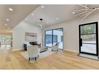 Modern living room with hardwood floors, large windows, and stylish furniture at 5255 Buice Rd, Alpharetta, GA 30022