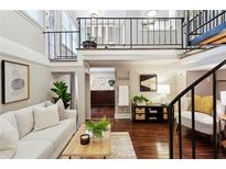 Open living room with high ceilings, hardwood floors, and a loft at 1078 Piedmont Ne Ave # 106, Atlanta, GA 30309