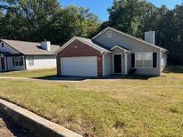 Cozy one-story home with attached garage and front yard at 5606 Rockingwood Ct, Atlanta, GA 30349