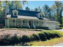 Gray house with white trim, covered porch, and attached garage at 10 Fox Run Ln, Mcdonough, GA 30253