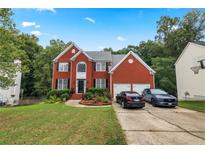 Brick house with a two-car garage and spacious yard at 1812 Beckley Nw Pl, Kennesaw, GA 30152