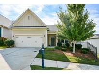 House exterior featuring a two-car garage and manicured landscaping at 418 Laurel Spring Ct, Canton, GA 30114