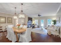 Open living and dining space with hardwood floors and fireplace at 211 Colonial Homes Nw Dr # 2106, Atlanta, GA 30309