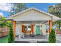 Charming white house with a covered porch and rocking chairs, well-maintained landscaping at 287 Church St, Dacula, GA 30019