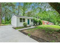 Ranch home with freshly painted brick and teal door at 408 Belgarde Place Se, Atlanta, GA 30354