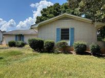 Brick ranch home with blue shutters and well-maintained lawn at 2071 Twin Falls Rd, Decatur, GA 30032