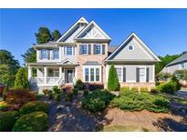Two-story home with brick and siding, a front porch, and nicely landscaped yard at 4508 Registry Nw Pl, Kennesaw, GA 30152