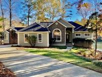 Ranch style home with stone accents and landscaped lawn at 7149 Burnside Ct, Villa Rica, GA 30180