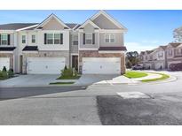 Modern two-story townhome with two-car garage and attractive landscaping at 179 Hampton Cir, Mcdonough, GA 30253