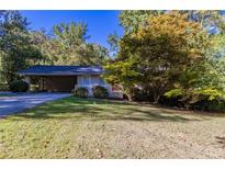 Ranch home with carport and well-maintained lawn at 8596 Timberlane Dr, Douglasville, GA 30134