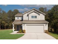 Two-story house with attached garage and landscaped yard at 3271 Forest Green Dr, Douglasville, GA 30135