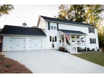 Two story home with white siding and two car garage at 4619 Spring St, Acworth, GA 30101