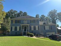 Two story blue house with attached garage at 1958 Stonewood Dr, Lithia Springs, GA 30122