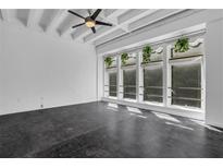 Spacious living room with exposed beams and large windows at 32 Peachtree Nw St # 204, Atlanta, GA 30303