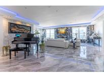 Elegant living room with marble floors, fireplace, and grand piano at 3334 Peachtree Ne Rd # 1209 1210, Atlanta, GA 30326