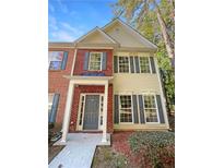 Two-story townhome with gray door and brick facade at 20 Pine Canyon Sw Dr # 24, Atlanta, GA 30331